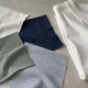Fabric swatches beside a folded T-shirt on a sample table